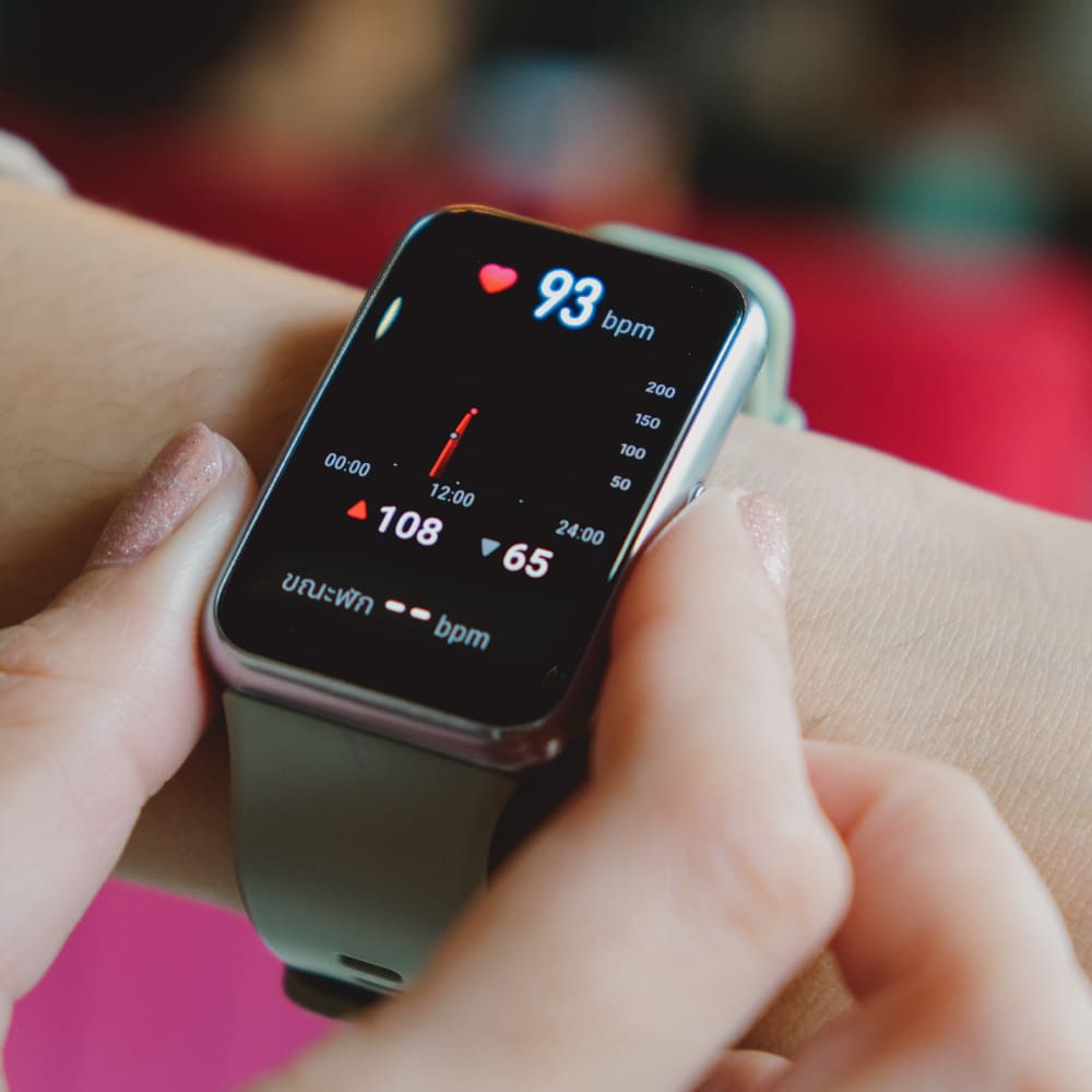 a close up of a person holding a smart watch.